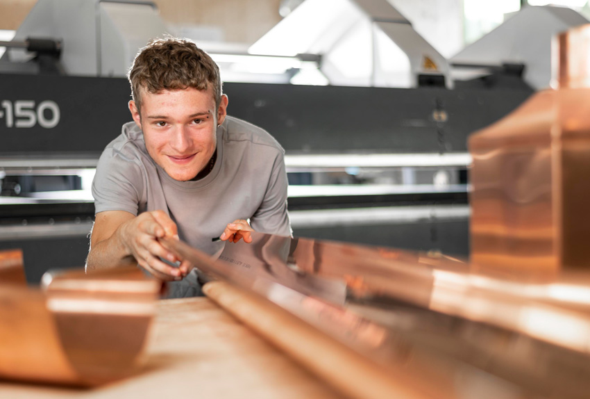 Spengler-Lernender bei der Arbeit in Werkstatt